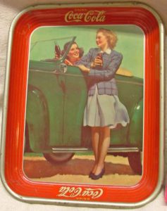 1942 Coca Cola Advertising Tray with woman at driver's wheel of a green convertible car and another woman standing and talking to her.