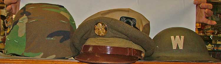 military hats - l to r - Kevlar, Army, Navy visor caps, WWI cap
