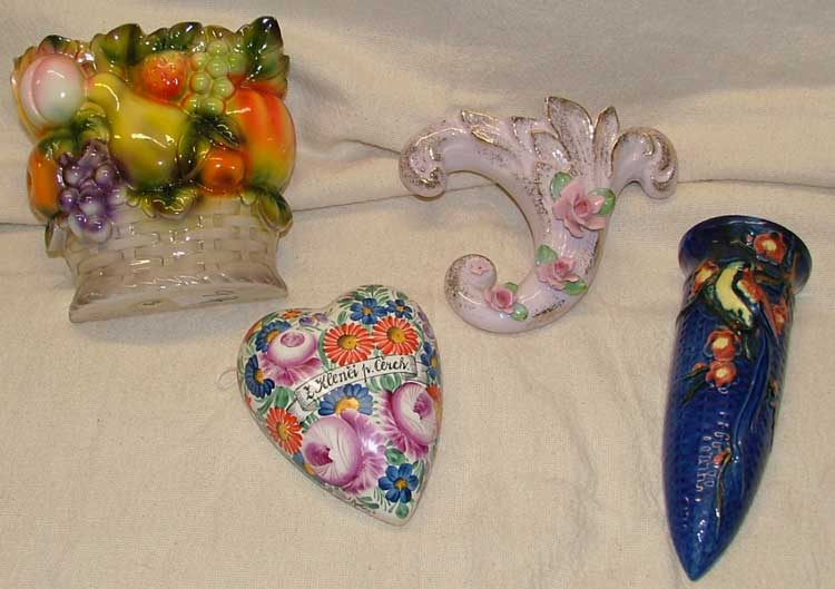 These delightful wall pockets include a fruit basket, cornucopia covered in rosebuds, Czechoslovakian heart shaped covered in flowers and a deep blue tube with design