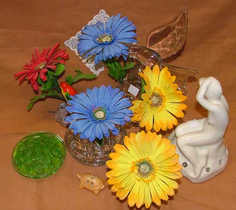 Various flower holders, some include sculpture or a candle holder