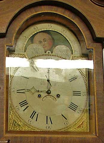 A closer view of the face of the grandfather clock