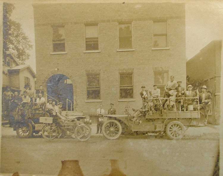 This old photo includes an early Harley Davidson