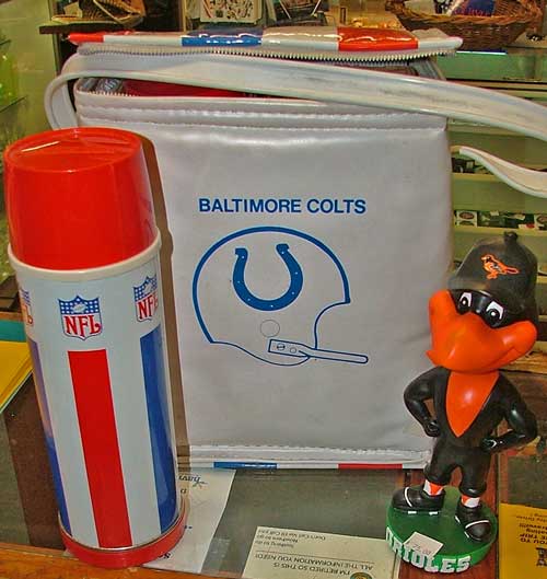 collectible Baltimore Colts thermos carrier and a B-more Orioles Bird at Bahoukas