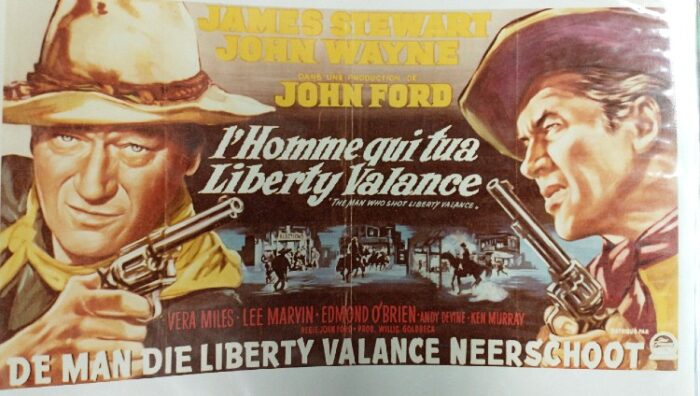 A lobby card for John Wayne and James Stewart for the movie, Who Shot Liberty Valence, in German