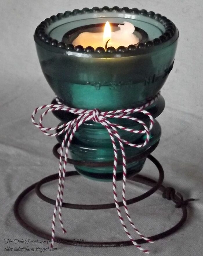 from pickledbarrel.com - a beautiful example of creating a candle holder for wedding decor from an old glass insulator.