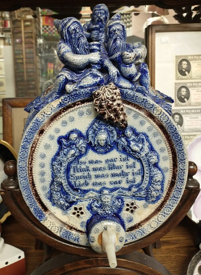 More detail of the gnomes and design on this German cobalt blue and white stoneware wine cask/dispnser
