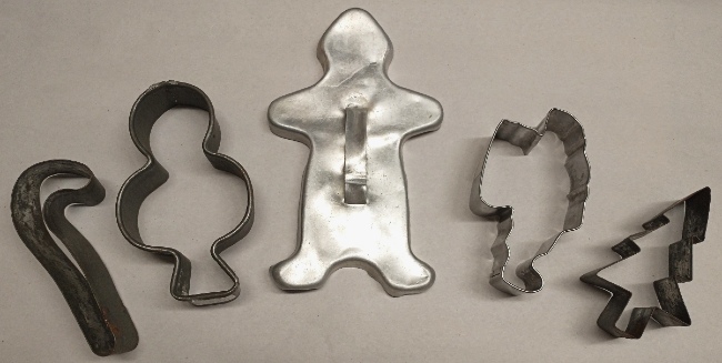 Christmas metal cookie cutters (the dark tin ones are from the 1930s - candy cane, snowman, gingerbread man, Santa, and tree