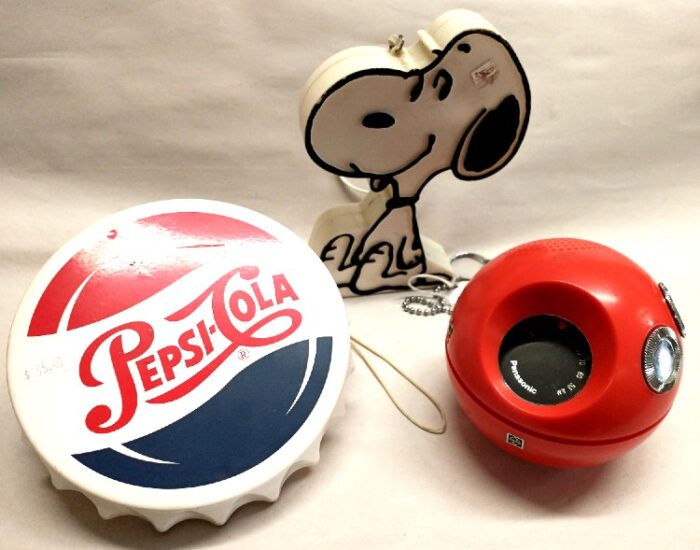 Pepsi Cola bottle cap styled radio 1998, 1970s Panapet Red Ball Radio, and a 1970s Snoopy character radio at Bahoukas