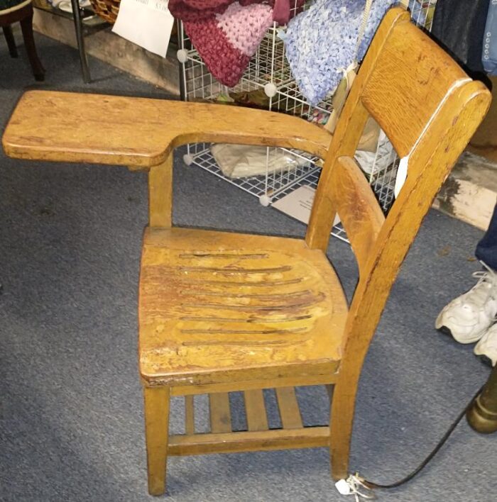 old wooden school chair with writing pad