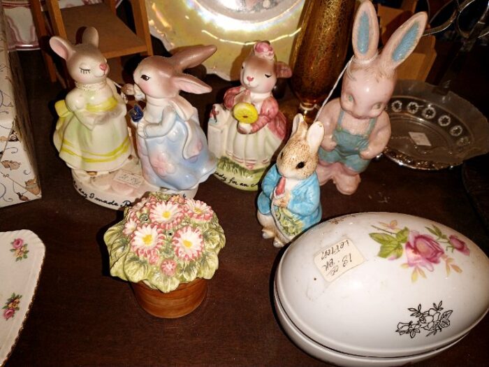 Several Bunny figurines and a large ceramic egg