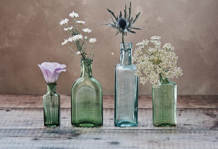 flower stems in old collectible bottles