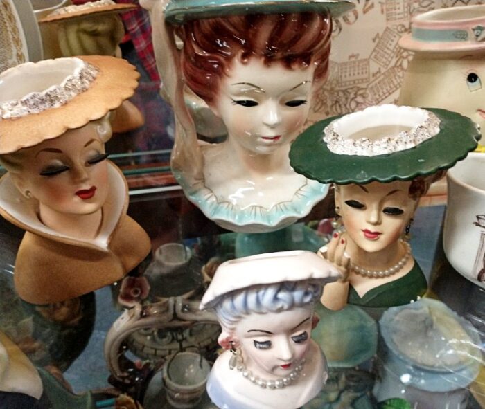 Beautifully detailed Lady Head vases - some with earrings, necklace, and painted nails on hand