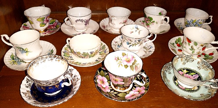 a variety of teacups and saucers