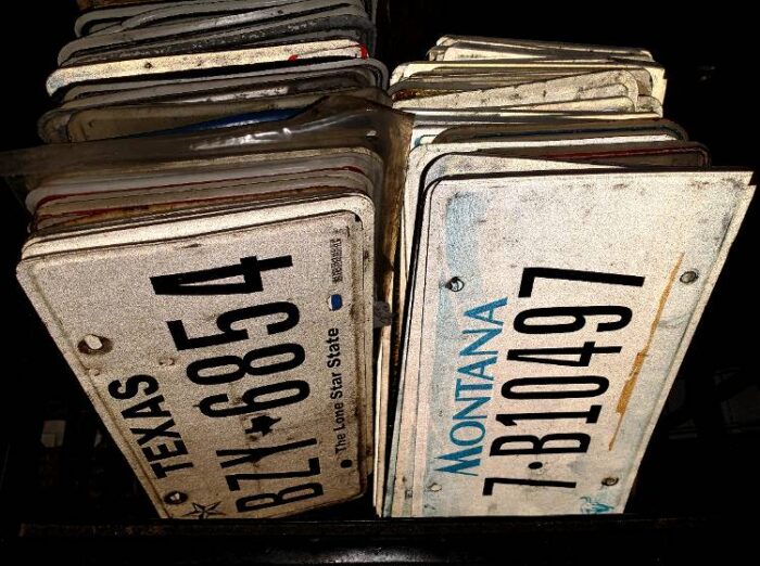 crate of vintage license plates