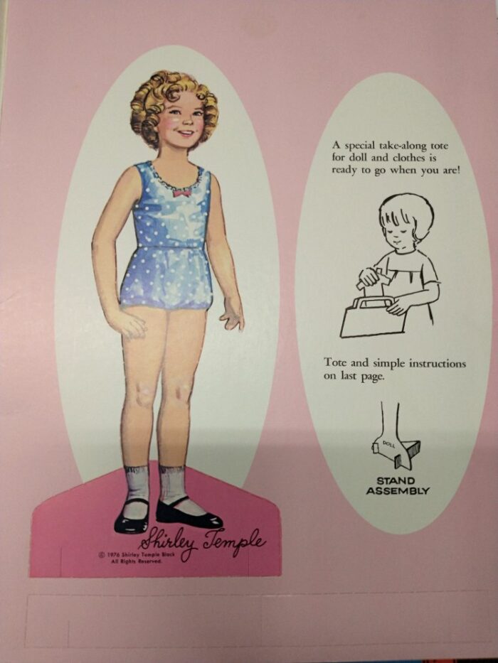 This shows what's included with the paper dolls - a stand and a little tote you put together to carry the paper doll clothes. Available at Bahoukas in Havre de Grace
