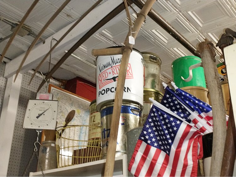 Look up at Bahoukas Antique Mall to see a wide variety of collectibles - hay rake, old cans, flags, and more