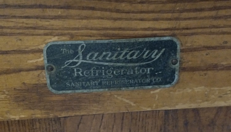 tag on an oak ice chest by the Sanitary Refrigerator Company available at Bahoukas Antique Mall