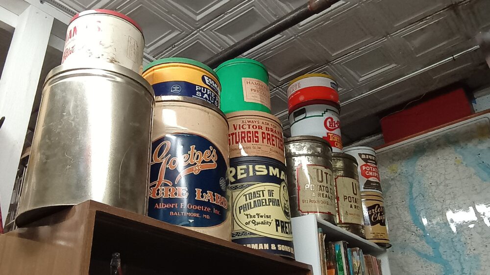 Tins of all shapes and sizes including large potato chip cans and more available at BAHOUKAS ANTIQUE MALL in Havre de Grace, MD