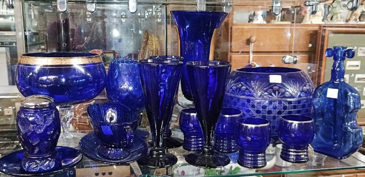 beautiful display of blue glass - part of the 'Collections' that can be found at BAHOUKAS ANTIQUE MALL in Havre de Grace MD