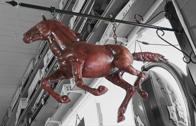 A stunning copper Galloping Horse hanging from a cast-iron bracket available at Bahoukas Antique Mall in Havre de Grace MD