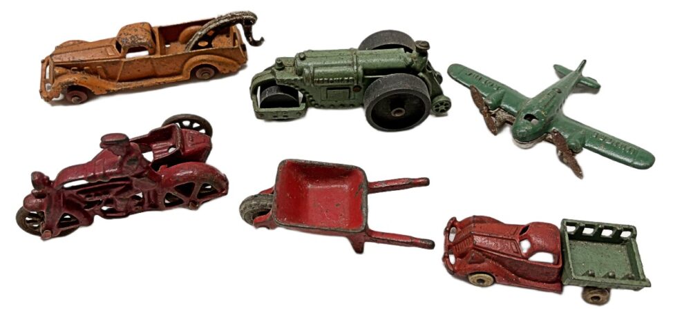 1930s cast iron vehicles by Hubley. Wheel Barrow is Arcade. Available at BAHOUKAS ANTIQUE MALL in Havre de Grace, MD